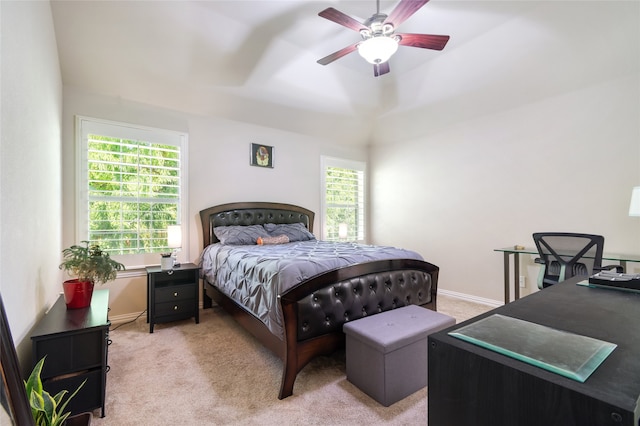 carpeted bedroom with ceiling fan and multiple windows