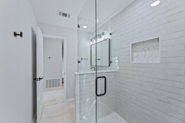 bathroom with walk in shower and tile patterned flooring