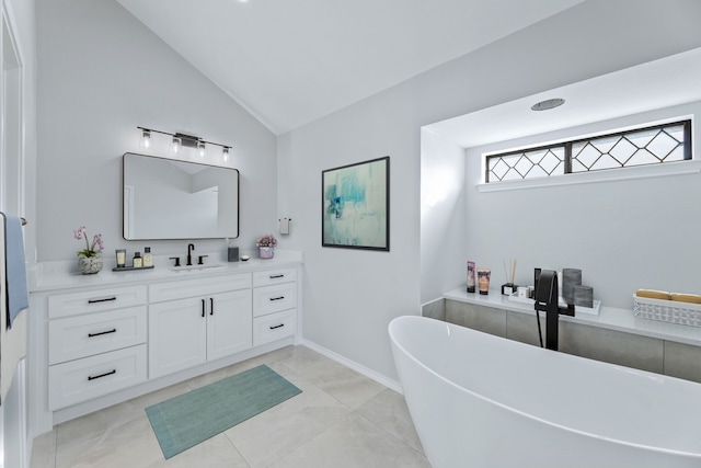 bathroom featuring vanity, a tub to relax in, tile patterned floors, and lofted ceiling