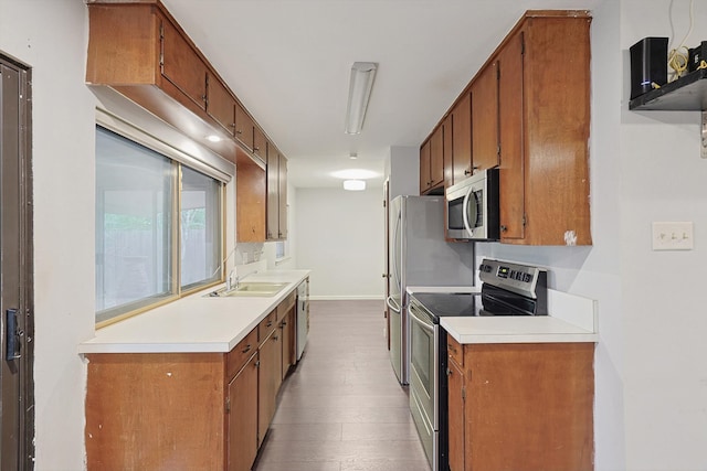 kitchen with light wood-type flooring, appliances with stainless steel finishes, and sink