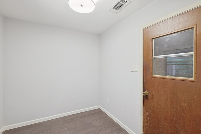 unfurnished room with dark hardwood / wood-style flooring