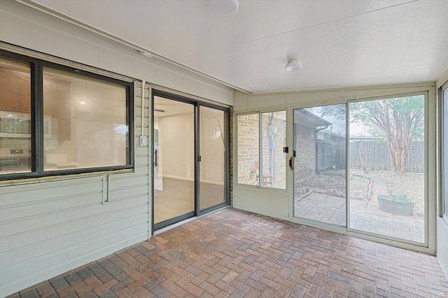 unfurnished sunroom with lofted ceiling