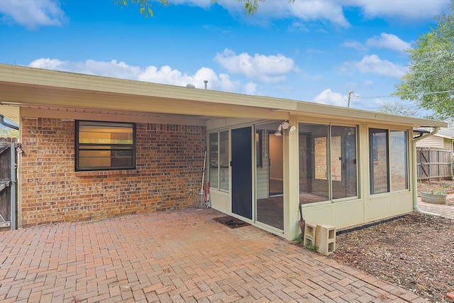 back of house with a sunroom and a patio