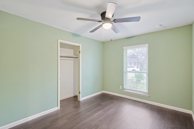 unfurnished bedroom with hardwood / wood-style floors, ceiling fan, and a closet