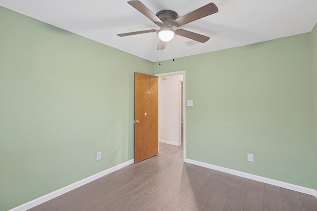 unfurnished room featuring hardwood / wood-style floors and ceiling fan