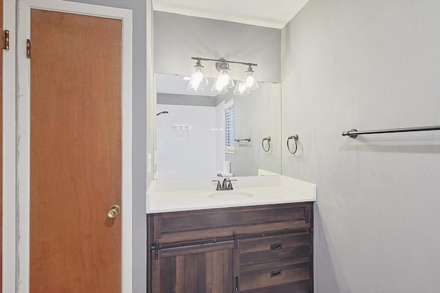 bathroom with vanity and a tile shower