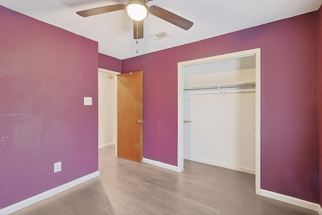 unfurnished bedroom with a closet, ceiling fan, and light hardwood / wood-style flooring