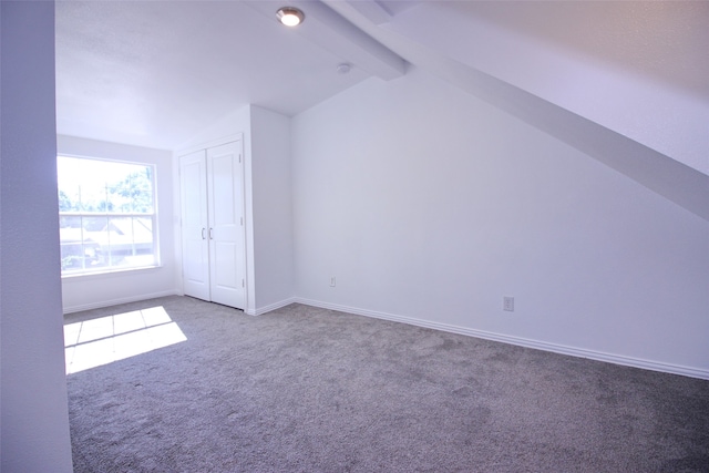 bonus room featuring carpet floors and vaulted ceiling with beams