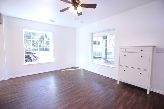 unfurnished room with ceiling fan, dark hardwood / wood-style flooring, and a healthy amount of sunlight