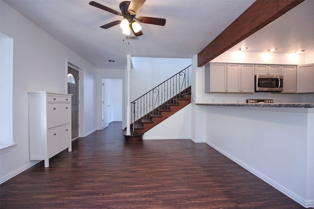 interior space with beamed ceiling and dark hardwood / wood-style flooring