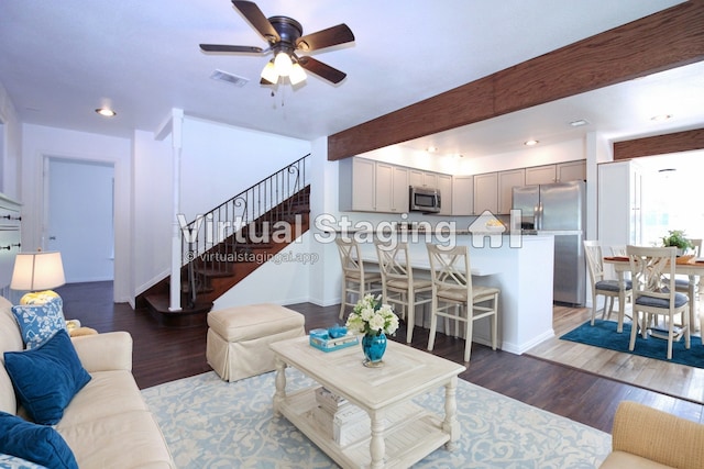 living room featuring ceiling fan and dark wood-type flooring