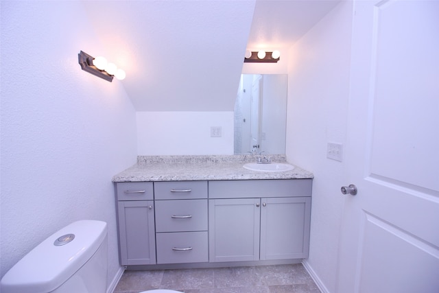 bathroom featuring vanity, toilet, and tile patterned floors