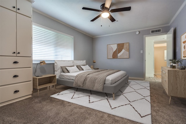 carpeted bedroom featuring ceiling fan and crown molding