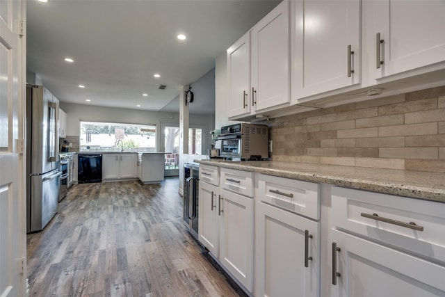 kitchen with stainless steel refrigerator, black dishwasher, light stone counters, hardwood / wood-style floors, and white cabinets