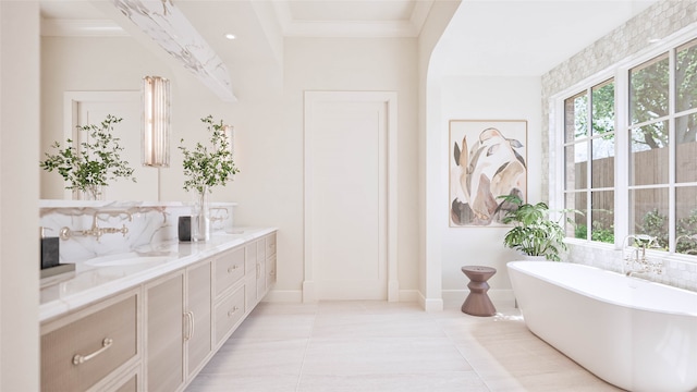 bathroom with tile patterned floors, vanity, a washtub, and crown molding