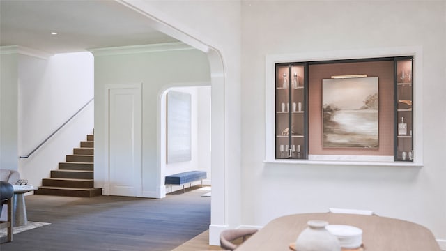 dining room featuring dark hardwood / wood-style floors and ornamental molding