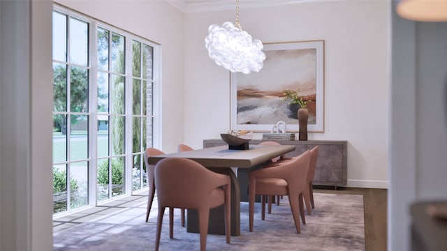 dining room with wood-type flooring, a notable chandelier, plenty of natural light, and crown molding