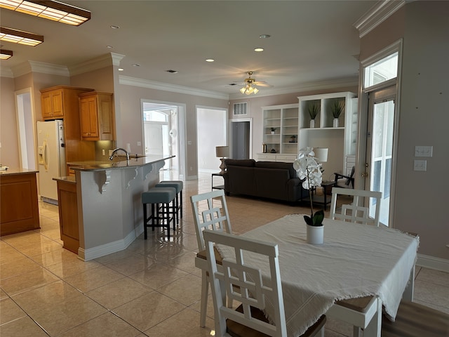 dining room featuring ornamental molding, ceiling fan, and a wealth of natural light