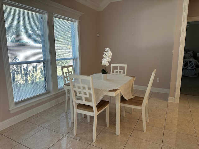 tiled dining area featuring crown molding