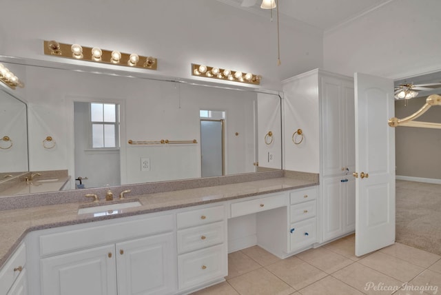 bathroom featuring a shower with door, ceiling fan, vanity, crown molding, and tile patterned flooring