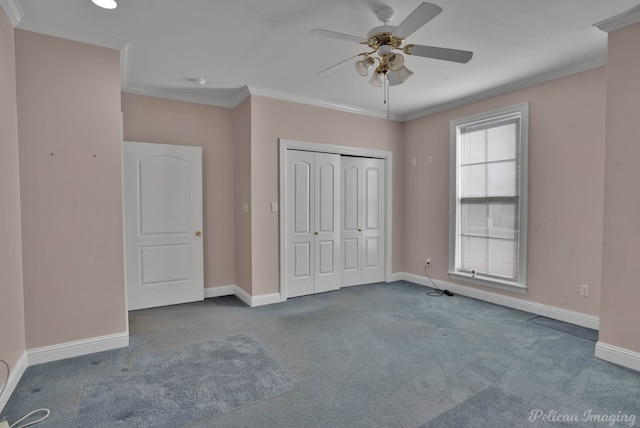 unfurnished bedroom featuring a closet, ceiling fan, crown molding, and carpet flooring