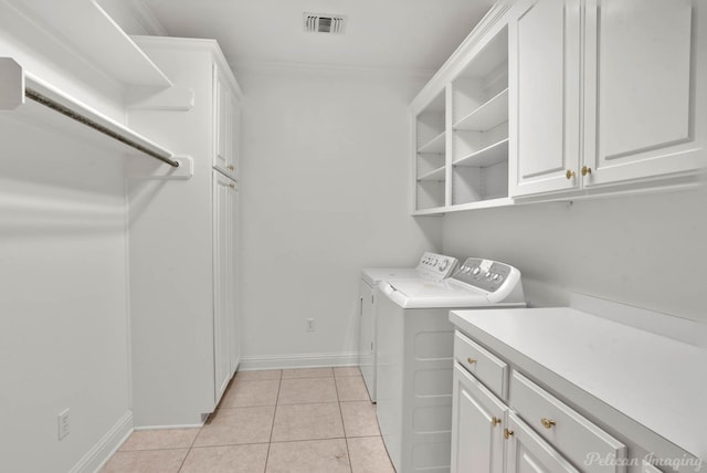 laundry area featuring cabinets, independent washer and dryer, and light tile patterned floors