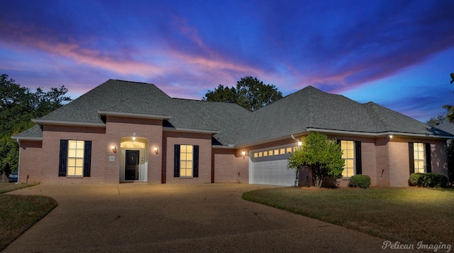 view of front of property featuring a yard and a garage