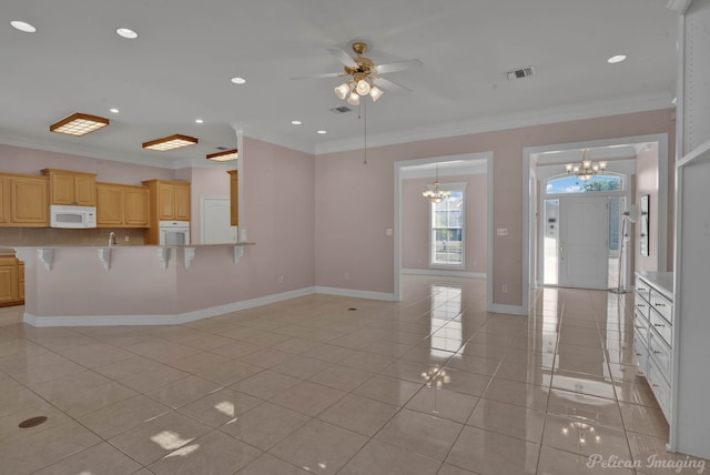 unfurnished living room with ornamental molding, ceiling fan with notable chandelier, and light tile patterned floors