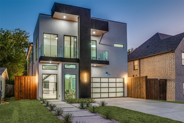 contemporary house featuring a lawn and a garage