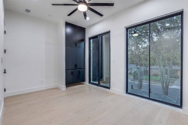 unfurnished room with ceiling fan and light hardwood / wood-style floors