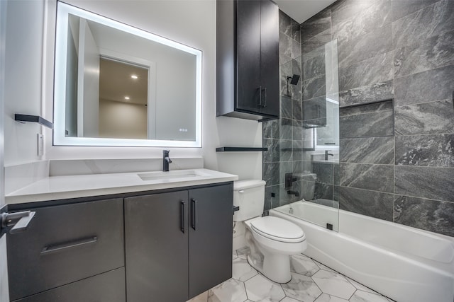 full bathroom featuring tiled shower / bath combo, vanity, and toilet