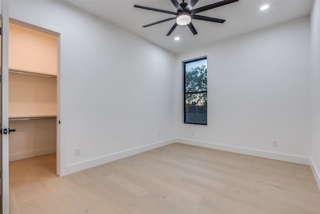 spare room featuring light wood-type flooring and ceiling fan