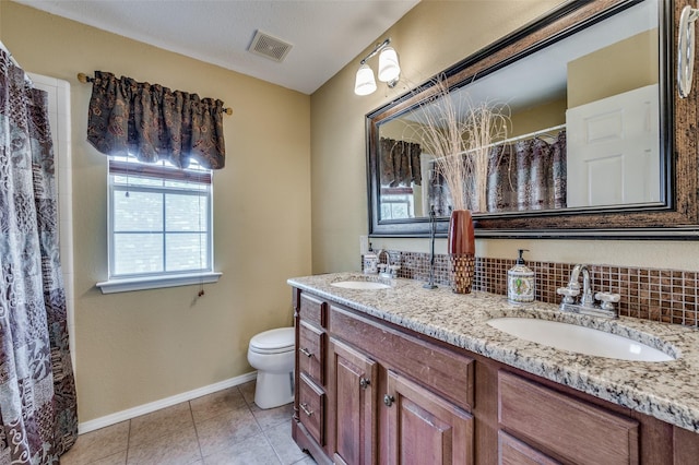 232 Touchdown Dr, Irving, TX 75063 - full bath with healthy amount of natural light, toilet, baseboards, and tile patterned flooring