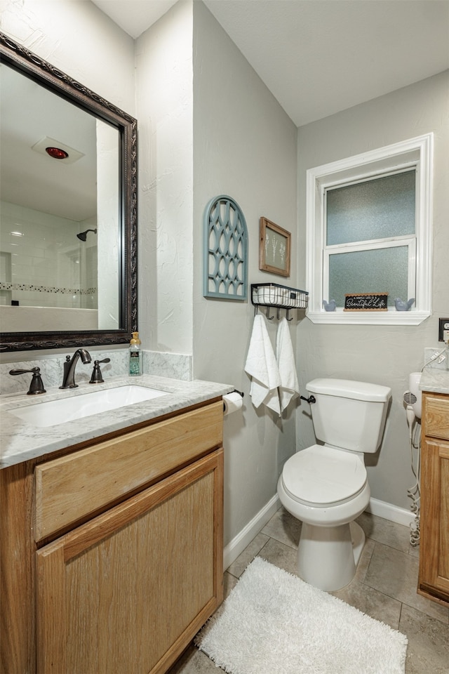 bathroom featuring a shower, tile patterned flooring, vanity, and toilet