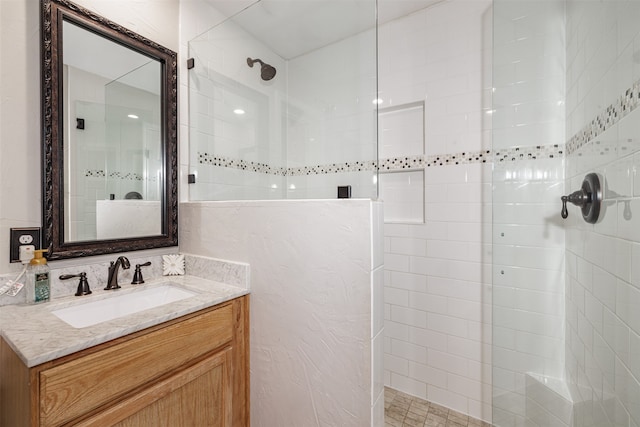 bathroom featuring vanity and tiled shower