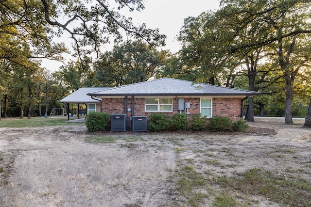 ranch-style home featuring central AC