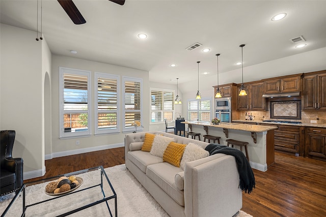 living room with dark hardwood / wood-style flooring and ceiling fan