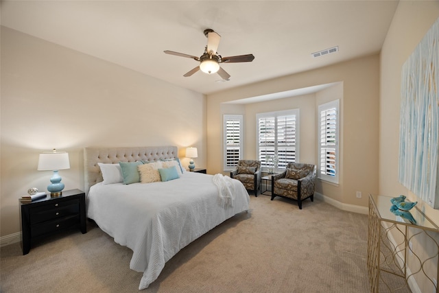 bedroom with ceiling fan and light colored carpet