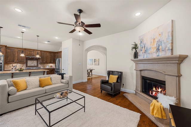 living room with dark hardwood / wood-style floors and ceiling fan