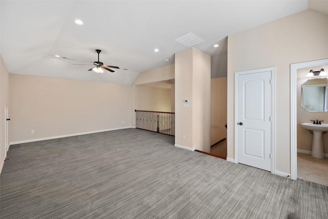 unfurnished room featuring carpet floors, sink, vaulted ceiling, and ceiling fan