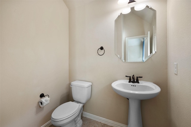 bathroom featuring toilet and tile patterned flooring