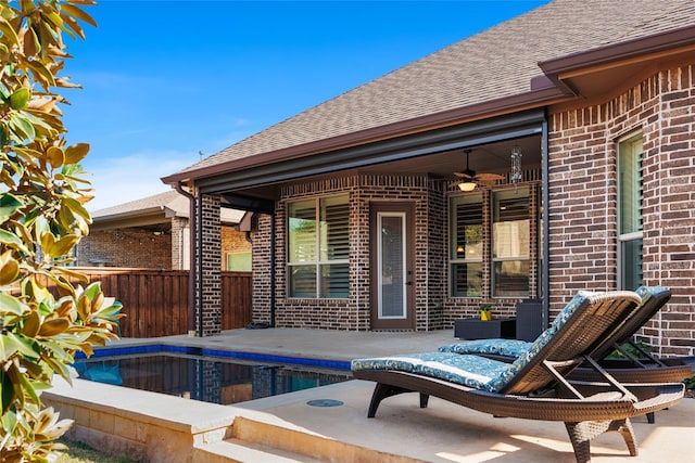 exterior space with a fenced in pool and ceiling fan