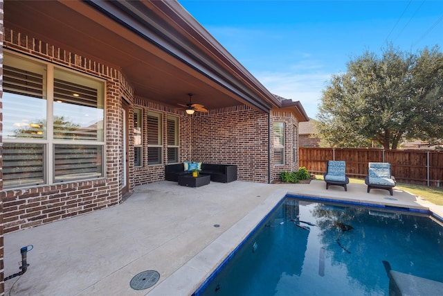 view of pool with ceiling fan and a patio