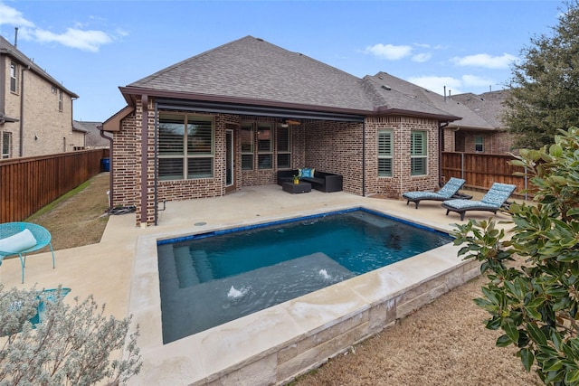 back of property featuring a fenced in pool and a patio