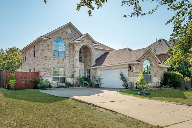 view of front of property featuring a garage and a front lawn