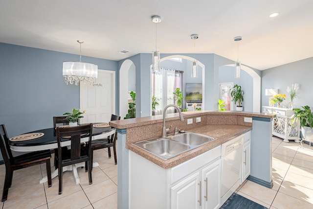 kitchen with white cabinets, sink, pendant lighting, a chandelier, and dishwasher