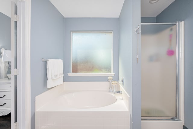 bathroom featuring separate shower and tub