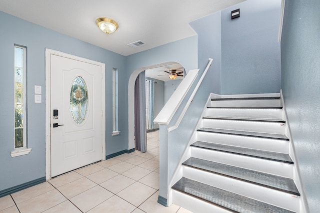 tiled foyer with ceiling fan