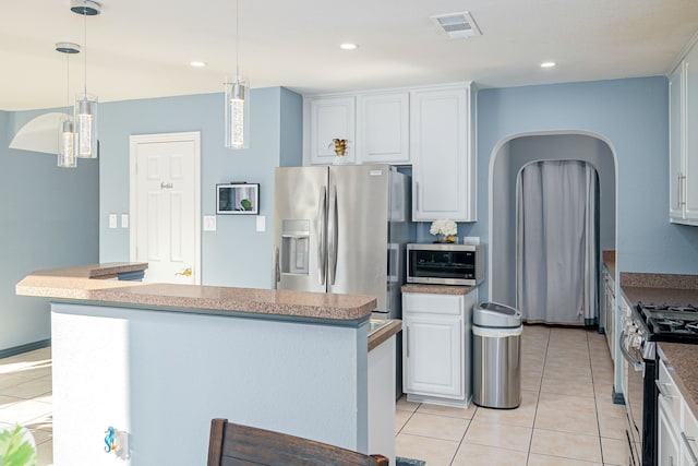 kitchen with a kitchen island with sink, white cabinetry, and stainless steel appliances