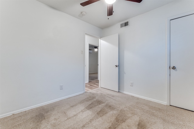 unfurnished bedroom with ceiling fan and light carpet